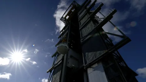 Crane lifting Boeing OFT-2 Starliner spacecraft at Vertical Integration Facility Stock Footage 274264859