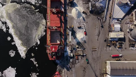 Crane lifting cargo from ship in icy canadian port Stock Footage 329452402