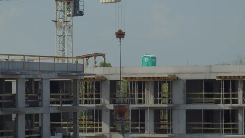 Crane Lifting Cement Bucket on Construction Site Stock Footage 283119666