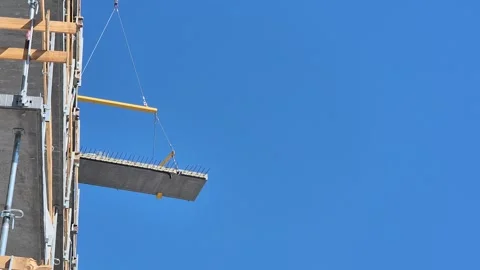 Crane Lifting Concrete Floor Slab on Sunny Day Stock Footage 338400668
