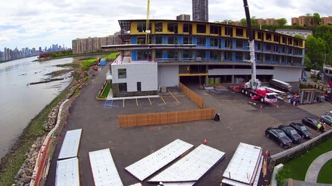 Crane lifting concrete slab at construction site Video stock 83693344