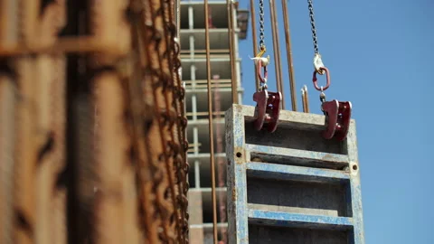 Crane lifting construction formwork at building site Stock Footage 314644875