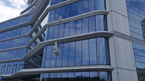 Crane Lifting Facade Panel with Tag Line for Stabilization Vídeos de archivo 332902637