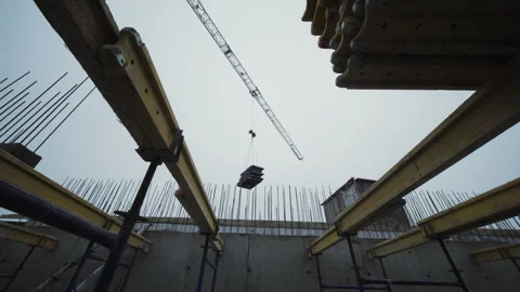 Crane lifting formwork inside unfinished concrete structure Stock Footage 327612286