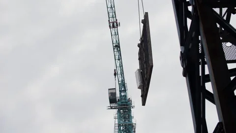 Crane lifting formwork panel at construction site Stock Footage 327747155