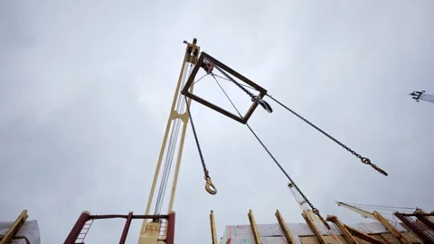 Crane Lifting Frame Sways in Wind - Low Angle View of Industrial Cargo Rigging Stock Footage 344078901