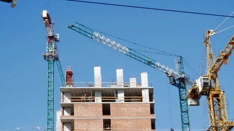 Crane lifting heavy blocks at building construction site Stockbeeldmateriaal 105580266