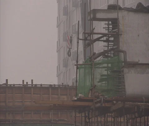 Crane lifting iron bars up to high-rise building construction Stock Footage 86744180
