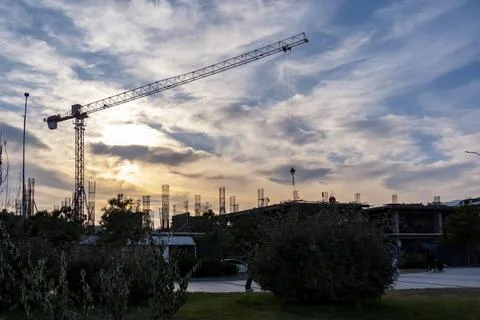 A crane is lifting a large object in the sky Stock-Fotos