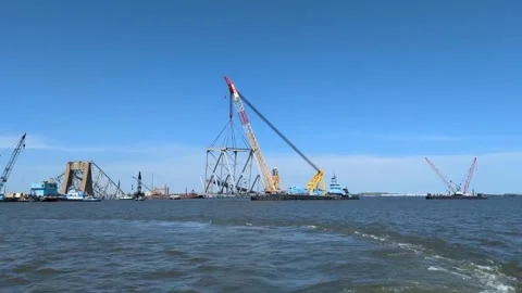Crane lifting large section of Key Bridge for removal from Patapsco River Stock Footage 272907591