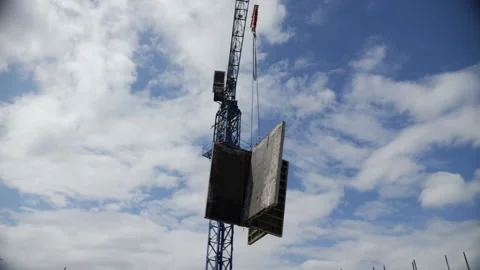 Crane lifting large yellow formwork panel vertically Stock Footage 314234242