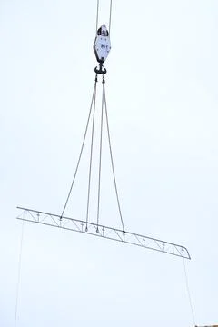 Crane lifting a metal structure Stock Photos