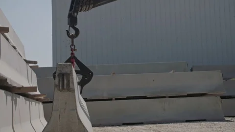 Crane lifting a part of a concrete wall at a construction site Stock Footage 109451087