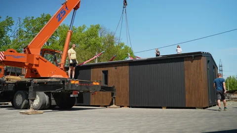 Crane lifting prefabricated modular house section onto foundation. Ternopil Video stock 316717877