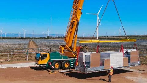 Crane lifting process for the assembly of electrical transformers in a phot.. Stock Photos