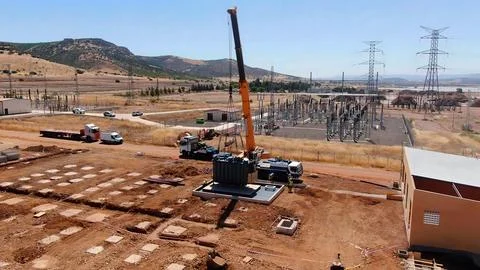 Crane lifting process for the installation of transformers and electrical c.. Stock Photos