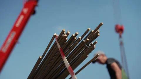 Crane lifting steel rebar bundle at construction site Stock Footage 341294329