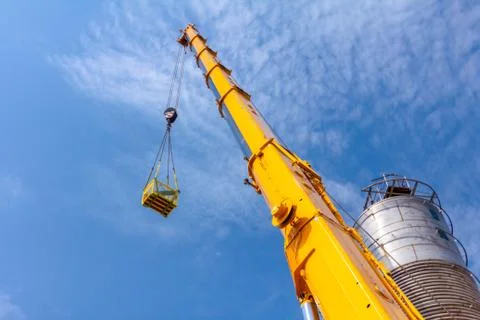 Crane is lifting work basket Stock Photos