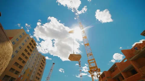 Crane lifts building materials for the construction of a multistory building Stock Footage 24293557