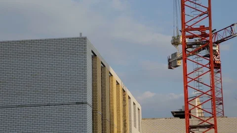 Crane lifts building materials to the construction of multi-storey buildings Video stock 101838067