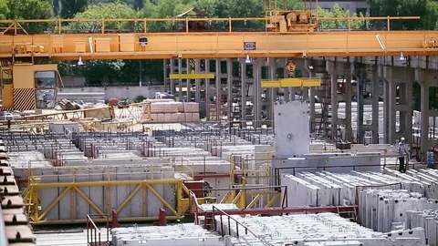 Crane lifts concrete slab on concrete factory Stock Footage
