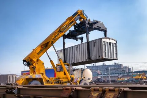 Crane lifts a container loading a train Stock Photos