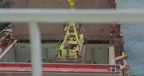 Crane lifts container from ship hold with mechanical rhythm Stock Footage 319832914