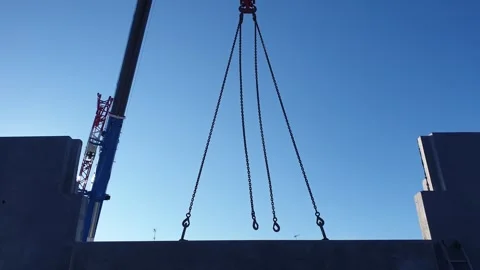 Crane lifts heavy wall panel for house construction, tilt-down Stock Footage 278961610