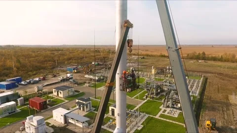 The crane lifts a large pipe, vertical aerial view Stock Footage 142494295