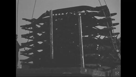 Crane lifts stack of chassis and unloads to production line of factory - 1939 Stock Footage 101983438