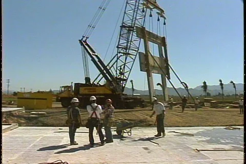 CRANE LIFTS WALL PAST WORKERS Stock Footage 1049754