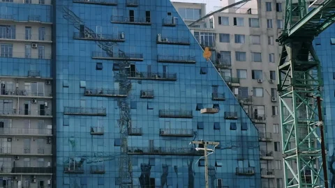 Crane with load operating on background of cityscape with modern architecture Stock Footage 280689659