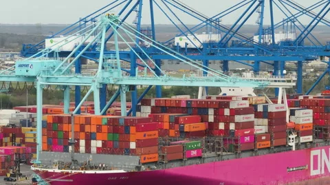 Crane loading cargo containers to container ship in international port terminal Stock Footage 294969902