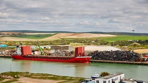 Crane Loading cargo Ship With Recycling Steel Stock Photos