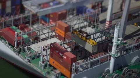 Crane Loading Containers onto Cargo Ship Tilt Shift Aerial Drone Footage Stock Footage 172155049