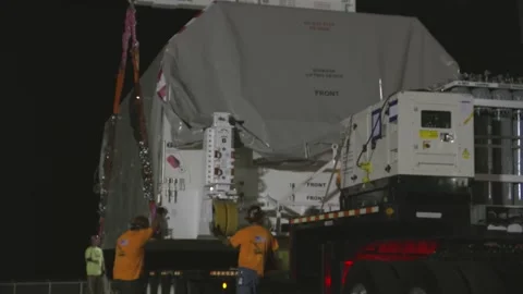 Crane loading NASA's Europa Clipper spacecraft onto trailer for transportation Stock Footage 281840295