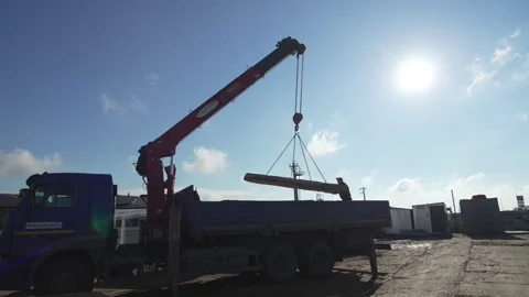 Crane loads plate into trailer at worker control outdoors Stock Footage 313829004