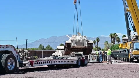 Crane loads U.S. Air Force Threat Training Facility armoured vehicle on trailer Stock-Footage 209493161