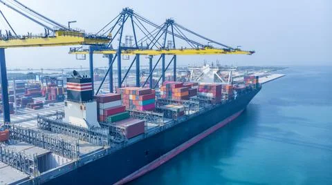 Crane loanding cargo container to container ship in the international termina Stock Photos