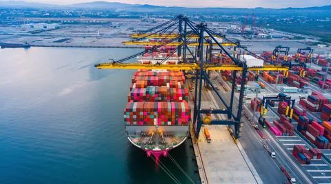 Crane loanding cargo container to container ship in the international termina Stock Photos