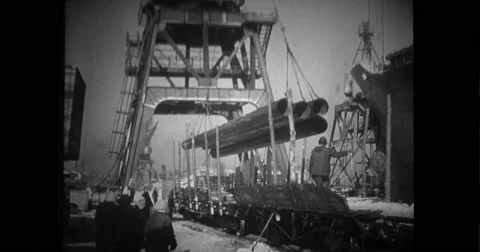 Crane lowering bundle of pipes into wagon Stock Footage 43495694