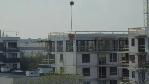 Crane Lowering Cement Bucket on Construction Site Stock Footage 283119674
