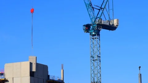 Crane lowering concrete section into place on building site in leeds uk Stock Footage 90377130