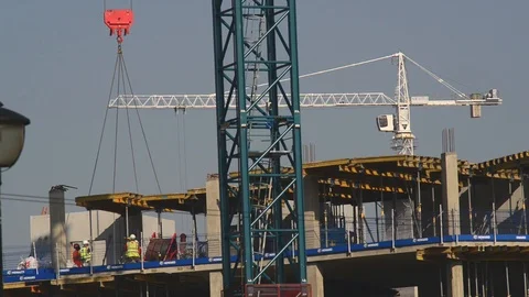 Crane lowering concrete section into place on building site in leeds uk Stock Footage 90427756