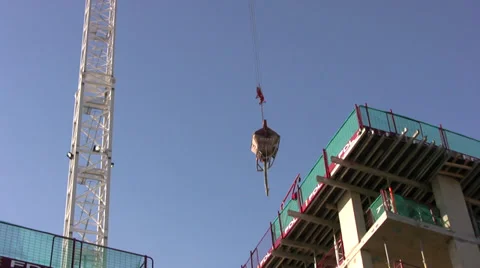 Crane lowering heavy load on a construction site Stock Footage 37190012
