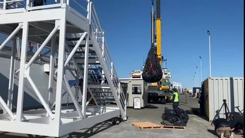 Crane lowering sack of drugs seized by US Coast Guard Vídeos de archivo 151251353