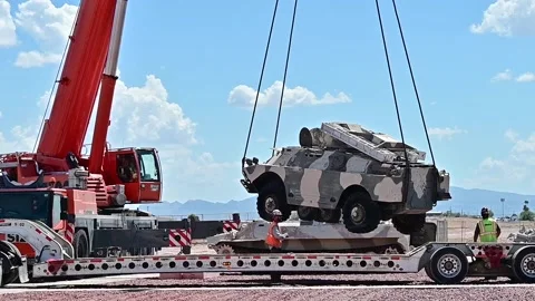 Crane lowering U.S. Air Force Threat Training Facility armoured vehicle  Stockbeeldmateriaal 209493095