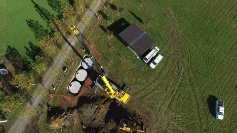 Crane lowering water tanks birds eye vie... | Stock Video | Pond5