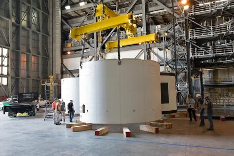 A crane lowers the third and final aeroshell for Orion's Launch Abort Syste.. Stock Photos