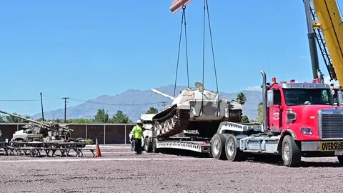Crane lowers U.S. Air Force Threat Training Facility armoured vehicle on trailer Vídeos de archivo 209492995